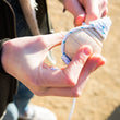 Load image into Gallery viewer, Wooden spinning top with string - yellow, coral, mint colours - jiminy eco-toys